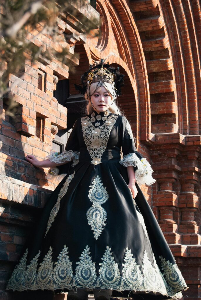 Victorian gothic dress against brick chapel